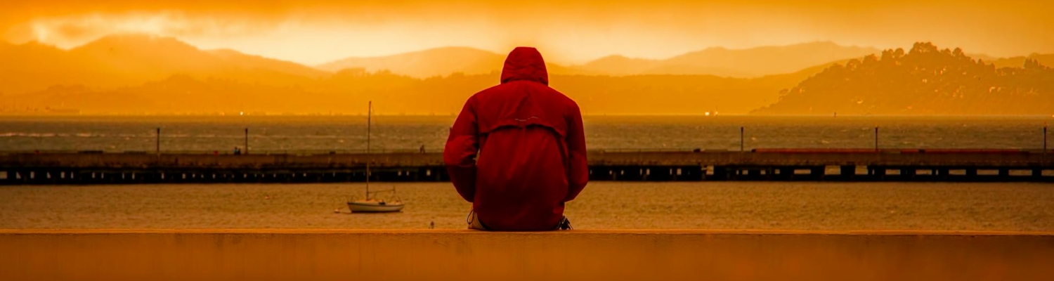 a man looking in the distance and thinking about what can trigger a depressive episode 